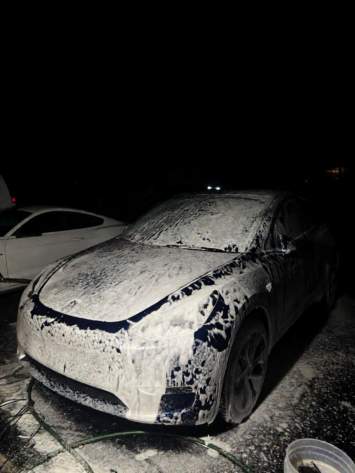 Car covered in foam during a Vortan wash and wax