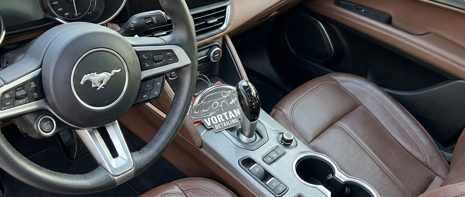 Mercedes-Benz interior with black steering wheel and saddle brown leather after detailing